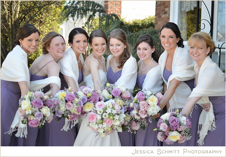 Bridesmaids in lavender dresses with white white shawls