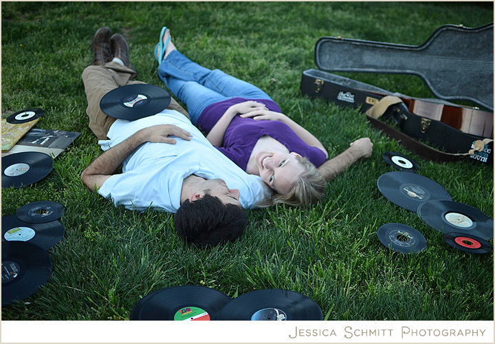 Engagement photography lying in the grass with guitar and vinyls