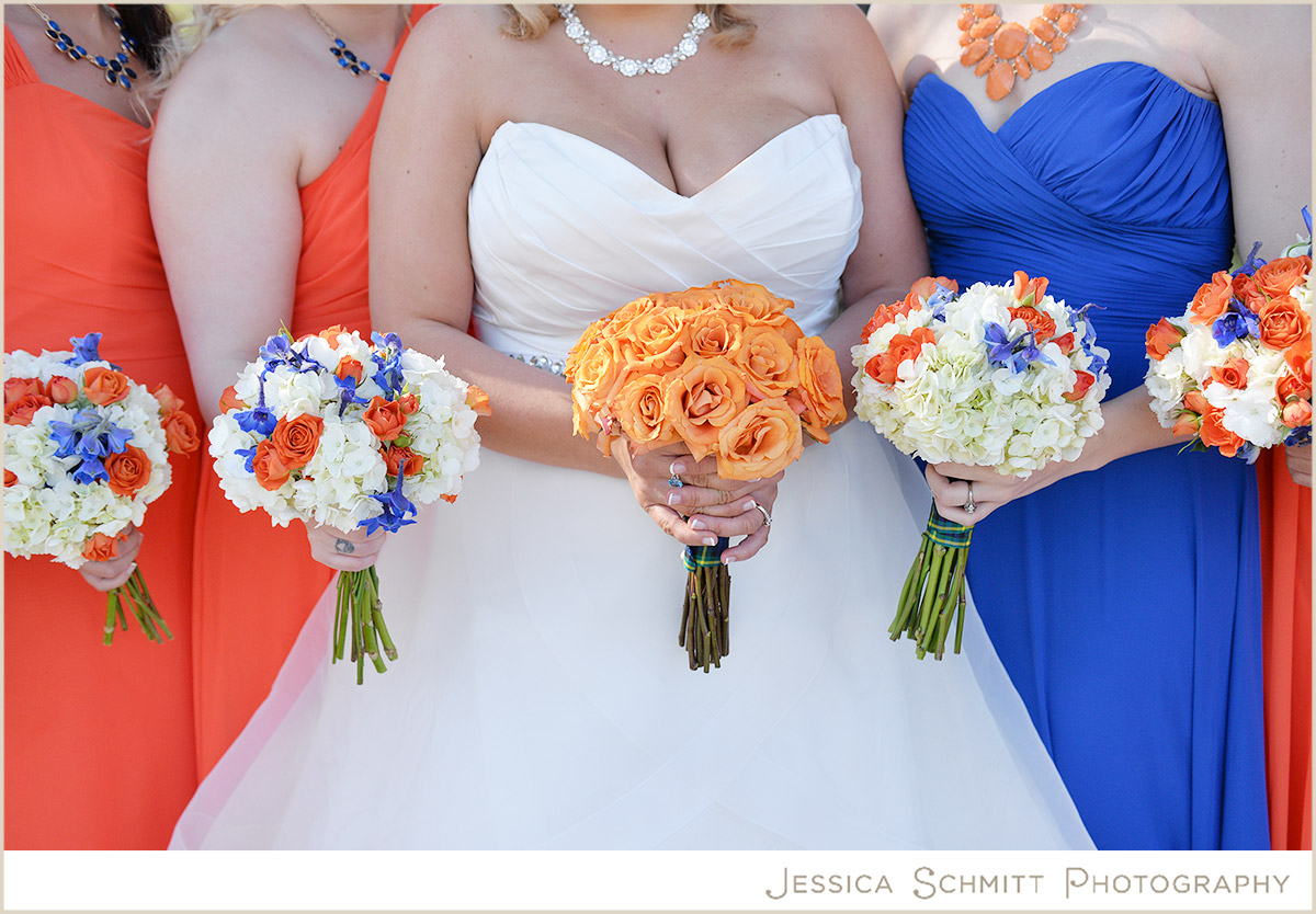 bridesmaids orange dresses flowers