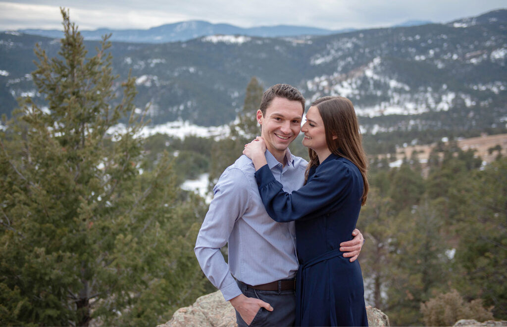 couple hugging, winter engagement session in colorado